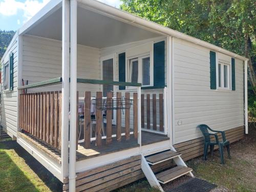 a screened in porch on a house with a chair at Camping Al Lago Ledro in Ledro