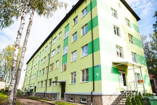 a building with green and white paint on it at Centrum Apartment in Valga