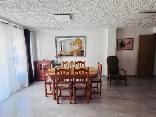 a dining room with a table and chairs at Spacious apartment 100m from the beach and promenade in Torrevieja