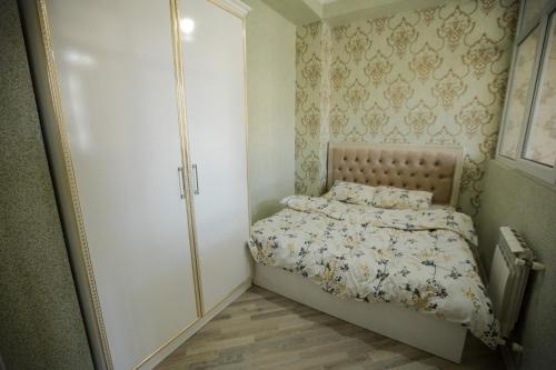 a small bedroom with a bed and a window at SelfHouse in Masazır