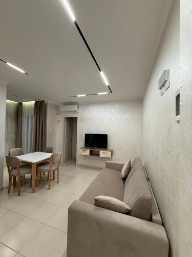 a living room with a couch and a table at Kamberi Hotel & Apartments in Velipojë