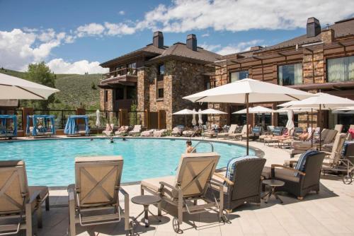 a patio area with chairs, tables and umbrellas at Sun Valley Resort in Sun Valley