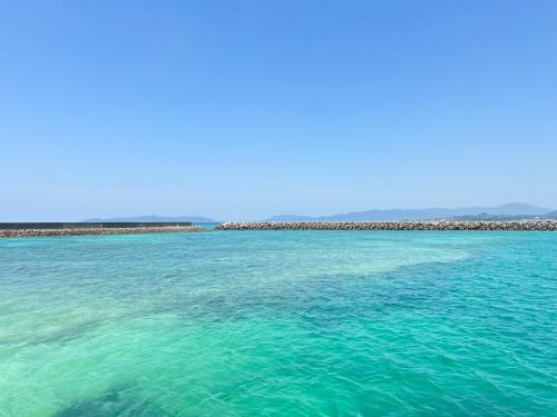 a large body of water with a beach in the background at Taketomijima Guesthouse and je Taime in Taketomi