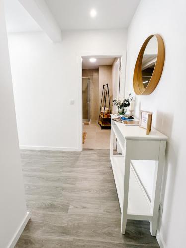 a hallway with a white table and a mirror at Douro's Heart Stay in São João da Pesqueira