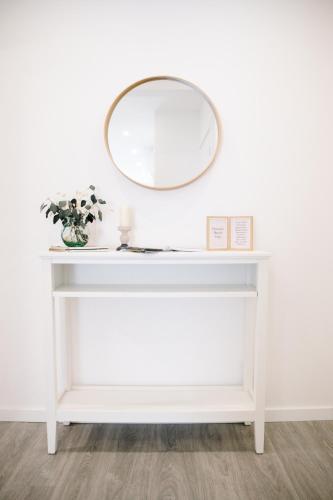 a white dressing table with a mirror on it at Douro's Heart Stay in São João da Pesqueira