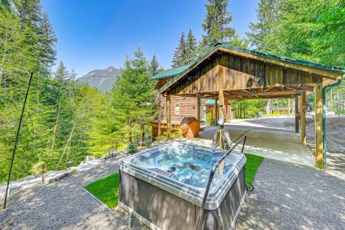 a hot tub in front of a cabin at Grizzly Tower Packwood Cabin with Hot Tub! in Packwood