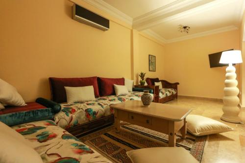 a living room with a couch and a table at Dar Guéliz in Marrakech