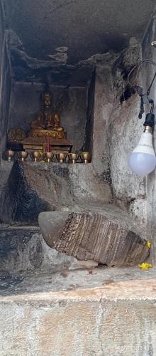 a room with a lamp and a shrine with a relic at Everest Home Stay Temal Kalimati Tower in Thapathali
