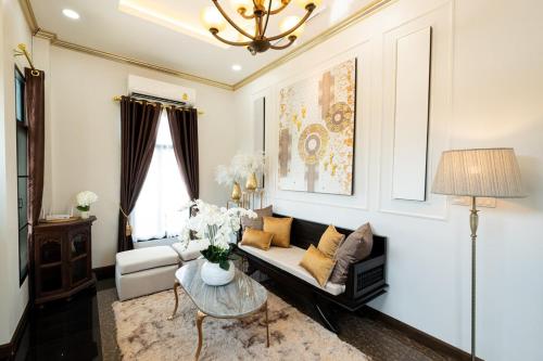 a living room with a couch and a table at Modern Lanna Style Grand Pool Villa in Chiang Mai