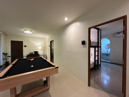 a pool table in a living room with a mirror at WANGTA Hostel in Baan Tai