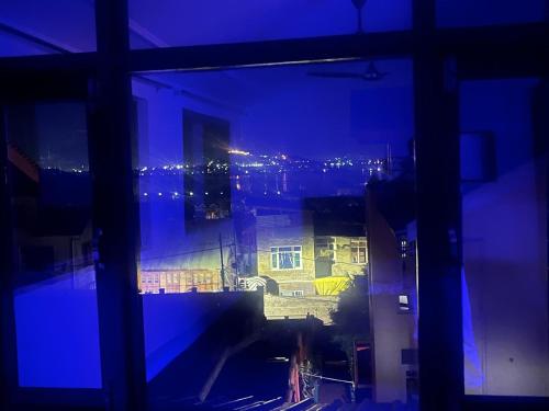 a view from a window of a building at night at Al Mubeen home stay in Nishāt