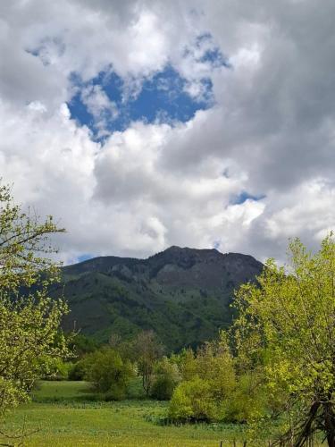 a view of a mountain under a cloudy sky at Bungalows Malagić in Gusinje