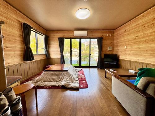 a room with a bed in the middle of a room at 貸別荘はこぶね -Vacation rental Hakobune- in Yufu