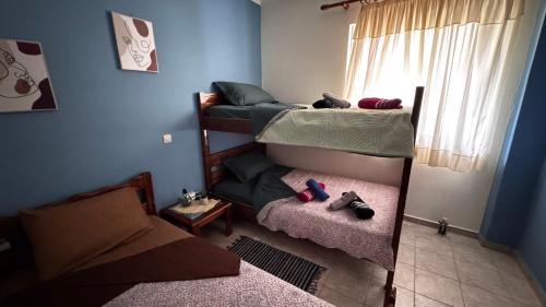 a room with two bunk beds and a window at Το Φιλόξενο Σπιτάκι! - The Friendly Nest ! in Paralion astros