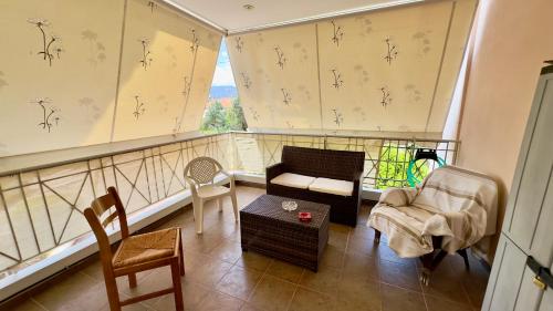 a living room with a couch and chairs and a window at Το Φιλόξενο Σπιτάκι! - The Friendly Nest ! in Paralion astros