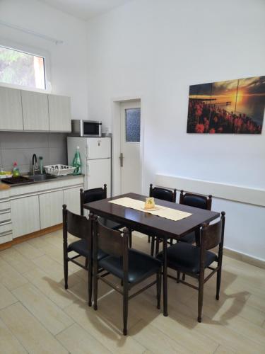 a kitchen with a dining room table and chairs at BIG APARTMAN BELA CRKVA in Bela Crkva