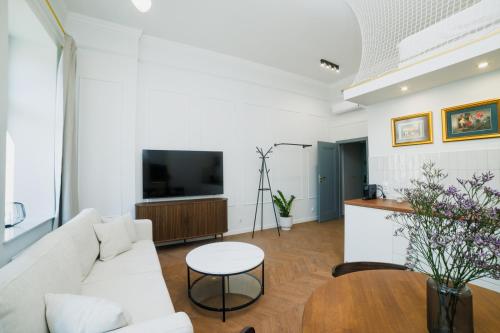 a living room with a couch and a table at Kołłątaja 23 Apartments in Wrocław