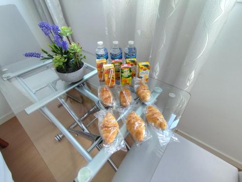 a refrigerator filled with bread and bottles of water at Habitacion Familiar LOVELY SEVILLA con baño compartido in Camas