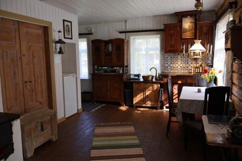 a kitchen with wooden cabinets and a table in it at Leesi Külalistemaja in Leesi