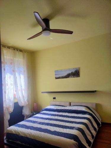 a bedroom with a ceiling fan and a bed at Dreaming of the Sea Albenga View in Albenga