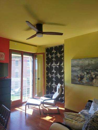 a living room with a ceiling fan and a couch at Dreaming of the Sea Albenga View in Albenga