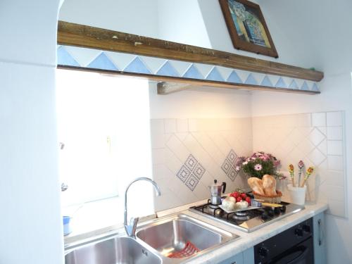 a kitchen with a sink and a counter top at L'ARCO DEI QUATTRO VENTI in Minori