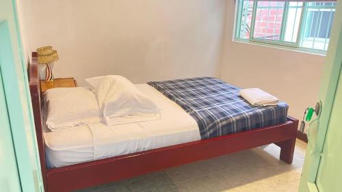 Un ou plusieurs lits dans un hébergement de l'établissement Sandalio Hostal Cali