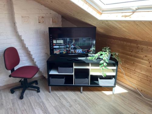 a desk and a chair in a room at Gaby's House in Liège