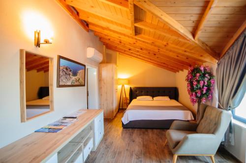 a bedroom with a bed and a desk in a room at İmroz Elia Hotel in Gokceada Town