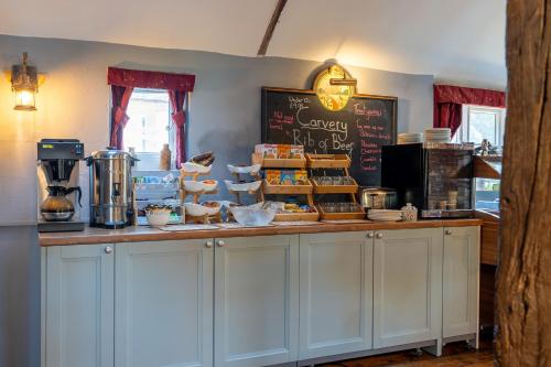 a kitchen with a counter with food on it at The Evenhill in Canterbury