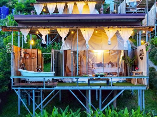 a house with a boat on the deck at Koya Homestay โกญ่า โฮมสเตย์ in Mae Rim