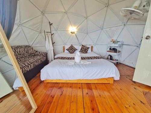 a bedroom with a bed in a tent at Koya Homestay โกญ่า โฮมสเตย์ in Mae Rim
