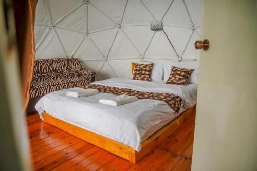a bedroom with a large bed and a couch at Koya Homestay โกญ่า โฮมสเตย์ in Mae Rim