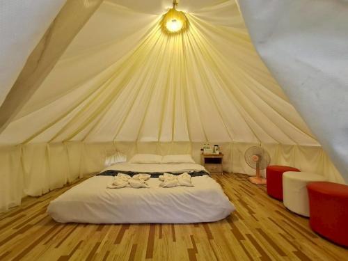 a bedroom with a bed in a tent at Koya Homestay โกญ่า โฮมสเตย์ in Mae Rim