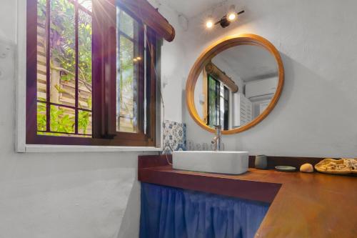 a bathroom with a sink and a mirror at BlueMoon Studio on the Beach! in Trou dʼ Eau Douce