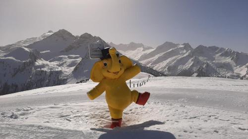 a person dressed in a costume running in the snow at Appartement Berghof "Dettis Place" in Gerlos