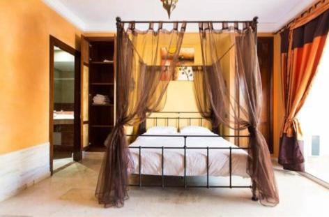 a bedroom with a bed with a canopy at Élégant Appartement de Standing à la Marina in Agadir