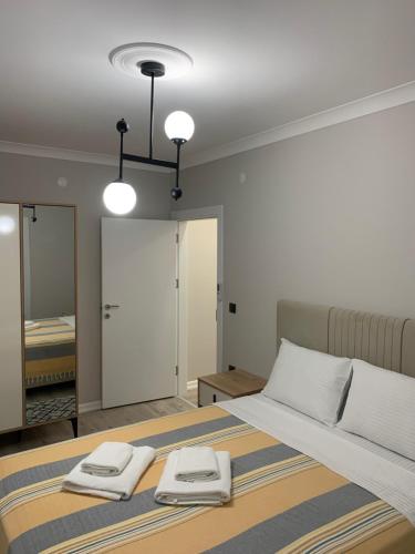 a bedroom with a bed with two towels on it at My Trabzon trend house in Trabzon
