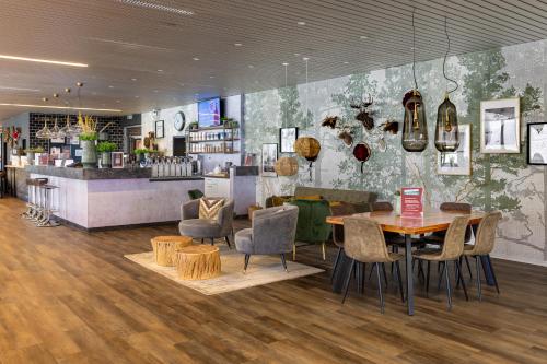 a restaurant with a table and chairs and a counter at M4 Apartments in Freiburg im Breisgau