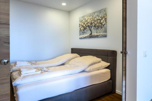 a bed in a room with a mirror at M4 Apartments in Freiburg im Breisgau