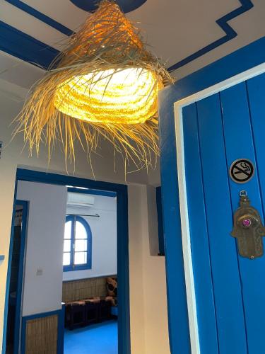 a light hanging from a ceiling next to a door at Etoile d Or Ksar Ait Ben Haddou in Aït Ben Haddou