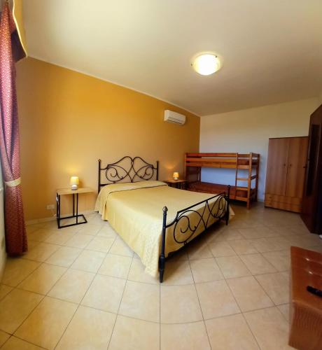 a bedroom with a large bed in a room at Tahiti House Stagnone in Marsala
