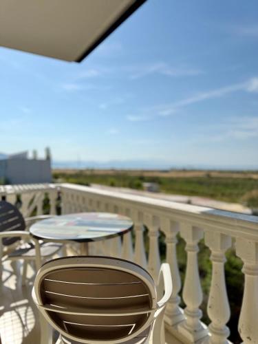 a patio with a table and chairs on a balcony at Kamberi Hotel & Apartments in Velipojë