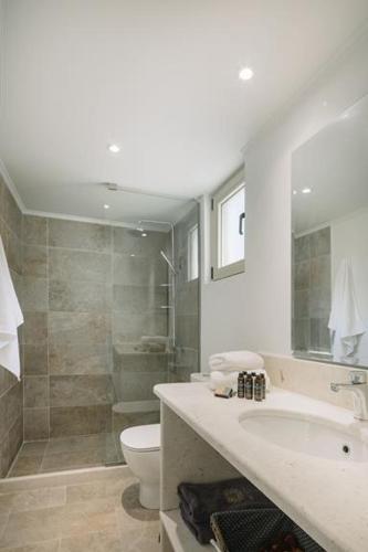 a bathroom with a shower and a sink and a toilet at Villa Sappho in Magaziá