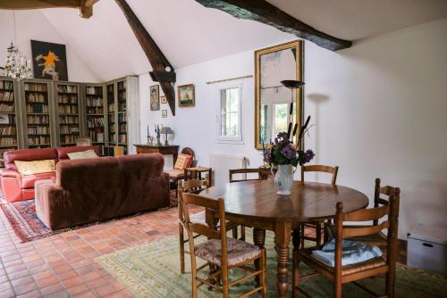 un salon avec une table et un canapé dans l'établissement Chambres d'hôtes Le Clos des Chaumes, proche Honfleur, à Saint-Maclou
