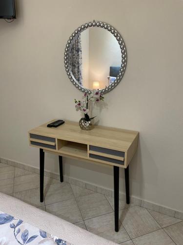a dressing table with a mirror on a wall at Villa Elia in Skala Sotiros