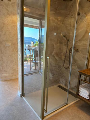 a glass shower door in a bathroom with a view at Coccolina, studio apartment with private hot tub, breathtaking views and free parking, bookable all year round, Also take a look at our flat Amor in Rabac