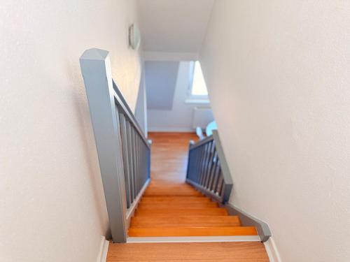 a staircase in a house with wooden floors at Le Duplex des Tulipes - Parking included - Haguenau in Haguenau