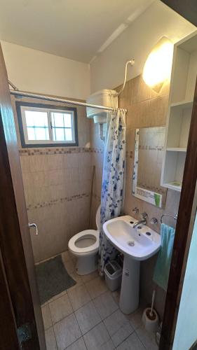 a bathroom with a sink and a toilet at Container Serrano in San Gerónimo