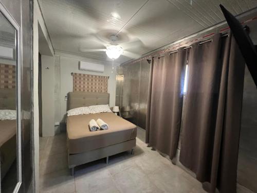 a bedroom with a bed with two shoes on it at Pura Vida Jungle Retreat - Montezuma in Montezuma